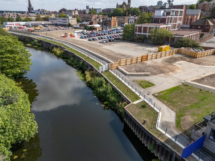 An aerial view of the completed riverside walkway in Rotherham links Water Lane to the town centre, supported by new sheet piling and concrete capping beams.