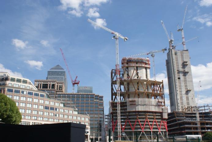 High rise buildings under construction with a tower crane and 1 Canada Wharf in the background