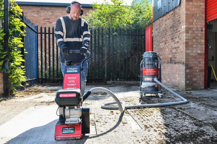 A man with beard using one of Trelawny’s new VoltMax range, which includes a grinder, scarifier and stripper – all powered by 82V lithium-ion batteries, prepares a surface for construction work