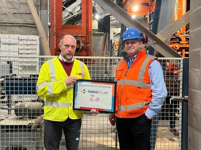 Chris Jones (right) of Mona Precast with David Wyke (left) of KVM, marking 25 years of block production at the Anglesey site.