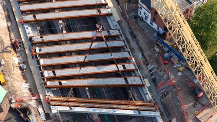An aerial view shows multiple new beams installed, spanning the 60 m gap created after dismantling the original 1958 bridge.