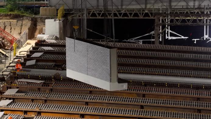 Precast parapet panels with a brick finish are craned into position to form the new bridge’s edge details.