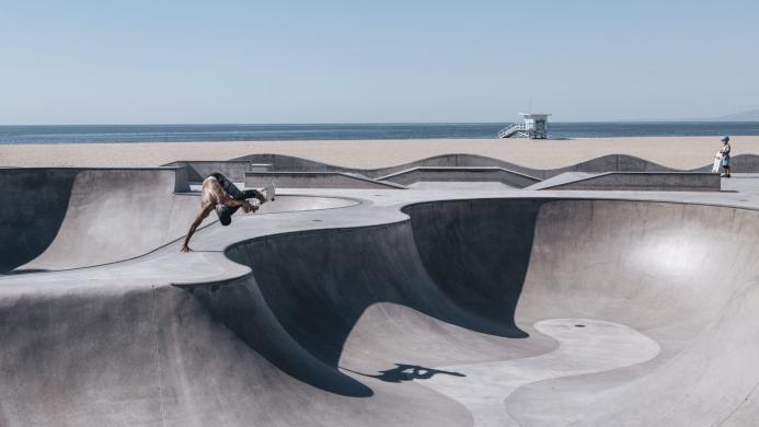 2024/25 Concrete in Life Winner, Venice Beach Skating by Henrik Hagerup shows a single skateboarder performing tricks at a concrete skatepark with the sea and beach in the background