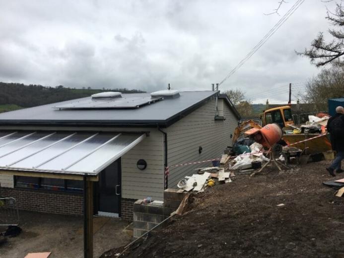 The incomplete concrete block retaining wall at Swainswick School collapsed after aggregate was placed against it.