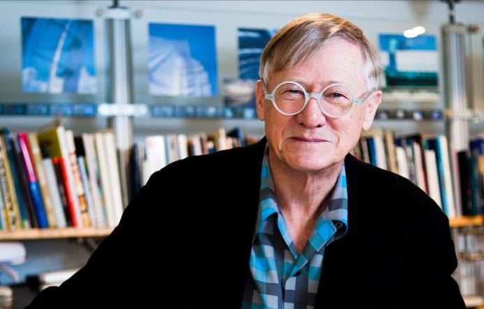 Sir Nicholas Grimshaw CBE PRA, 1939-2025 in his studio surrounded by books