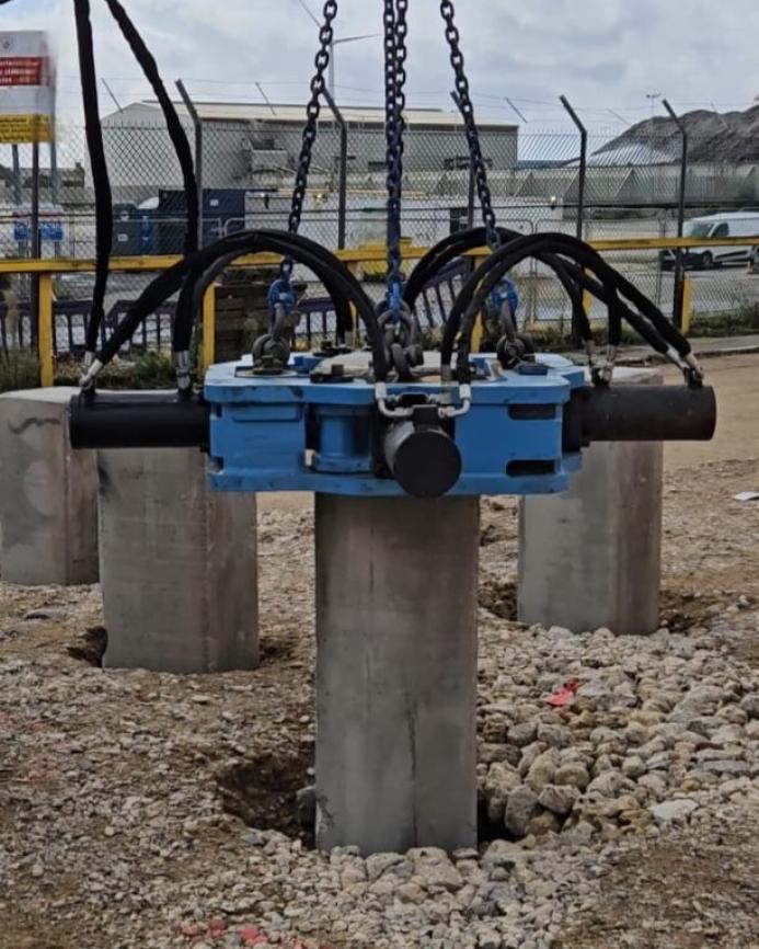 A close-up of a blue, National Pile Croppers PC400 hydraulic cropper in action at Holcim UK’s Tilbury site, precision-cutting 400 mm precast piles for Careys’ civil engineering works.
