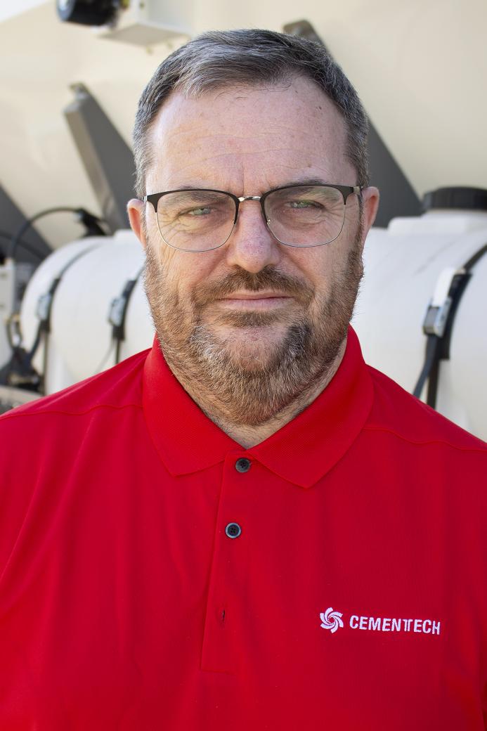 A head and shoulders photo of Steve Cartwright, General Manager, Volumech (Cemen Tech UK), in a red top, glasses, beard and greyish hair
