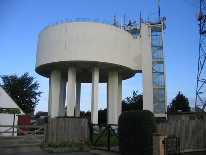 A view of a round concrete water tower and access tower