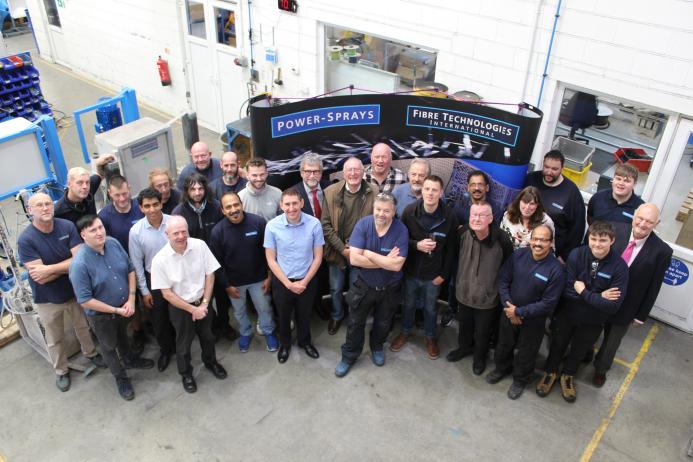 A group of workers in a factory photographed from above
