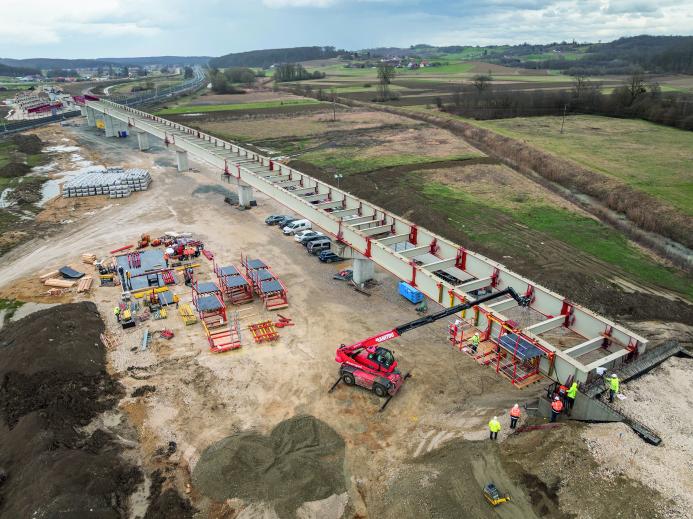 An under construction bridge in the countryside with construction machinery