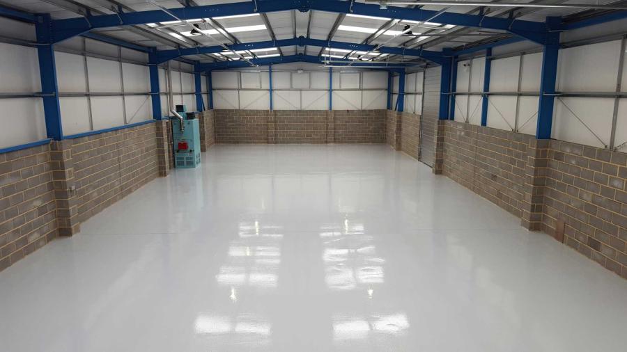 An interior view of an empty warehouse with an epoxy resin floor