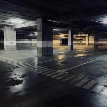 A dimly lit underground concrete carpark