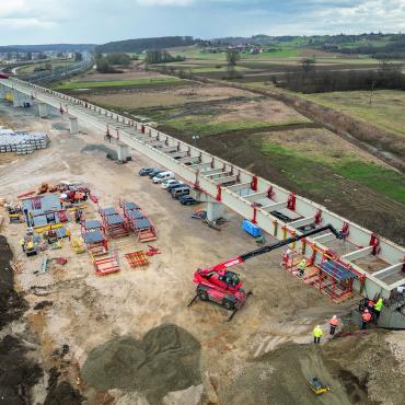 An under construction bridge in the countryside with construction machinery