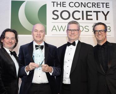 Four men holding an award