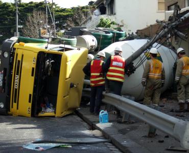 A concrete mixer truck on its side