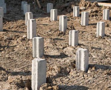 Concrete piling caps sticking out of the ground