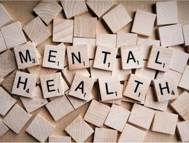 Wooden scrabble letter spelling Mental Health