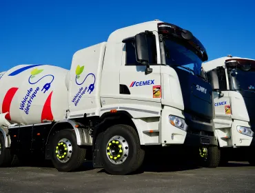 Two of Cemex's new electric trucks, which are designed for urban use, offering up to a 100% reduction in CO₂ emissions when powered by renewable energy and operate at significantly lower noise levels than traditional diesel-powered vehicles.