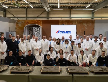 A group of people in white lab coats outside Cemex's GRD.
