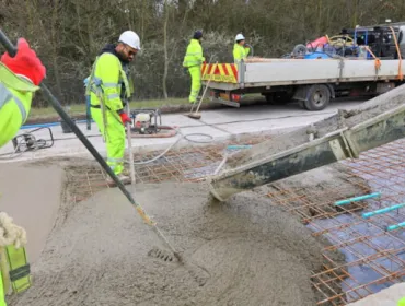 Men in PPE carry out repairs to the concrete road section of the M54