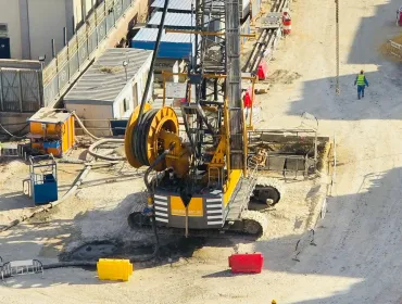 A view of a yellow Bauer piling rig at work on Cairo, Egypt's new metro station in Giza. In an estimated 14 months, Bauer Egypt will execute 209 diaphragm wall panels and 20 barrettes for Cairo's new metro station in the Giza district. Despite limited space and other challenges, work is progressing smoothly. Image: BAUER Group