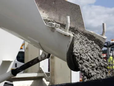 Concrete sliding off a delivery chute on a truck