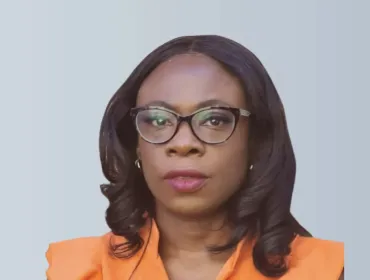 A head and shoulders picture of Ola Obadara FCIOB will serve as CIOB Vice President for 2025/26, the first black woman to hold the role, wearing an orange top and glasses with shoulder length hair