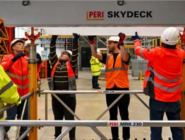 A group of PPE glad people receive formwork training from PERI UK, which delivers hands-on, accredited formwork training at its Brentwood facility and nationwide.