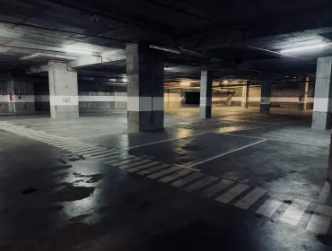 A dimly lit underground concrete carpark