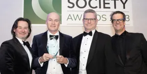 Four men holding an award