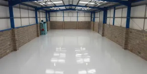 An interior view of an empty warehouse with an epoxy resin floor