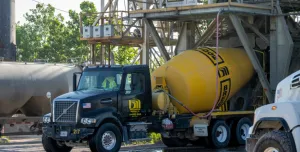 A blue and yellow concrete mixer truck