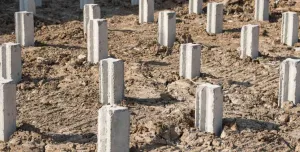 Concrete piling caps sticking out of the ground