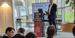 A man standing on a stage giving a speech