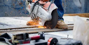 a close up of a circular saw cutting concrete