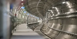 The inside of an under construction metro tunnel lined with precast concrete segments.