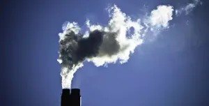 Smoke billowing out of an industrial chimney