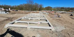Concrete beams lying on the ground at a construction site