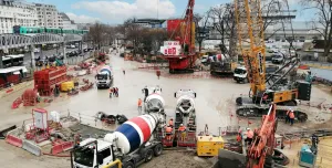 A crane, concrete mixer, excavator and other construction equipment helping pour concrete for the Austerlitz Basin in Paris
