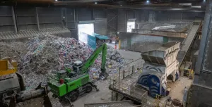 Inside SUEZ's recycling facility at Malpass Farm in Rugby, where Climafuel is produced in order to heat the kiln at Cemex's Rugby cement plant, a green material handler sorts waste