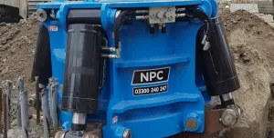 A close up of a blue pile cropper cutting a concrete pile