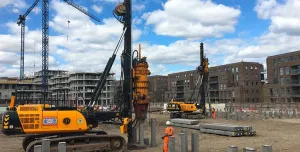 A yellow piling rig installing Precast Concrete Piles