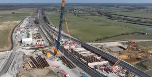 An aerial view of three cranes as the prepare to install bridge beam on the A43 for HS2, March 2025.