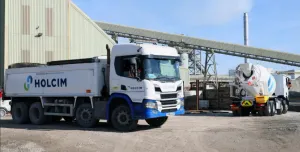 A white, Holcim branded truck at a cement works.