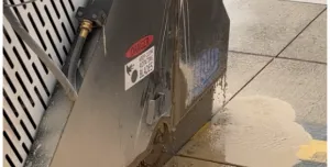 A diamond bladed saw cutting concrete paving slabs.