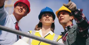 Three people in PPE. One in a red hard hat, one in blue and one in yellow.