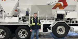 Derrick Murias, the new General Manager at ProAll, stand in front of a ProAll mixer.