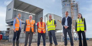 L–R: Prof. David Hughes; Bob Borthwick; Scott Bros recycling innovation engineer Feysal Shifa; Peter Scott; Joss Newberry; and Cassidy Smith, Teesside University’s IP and commercialization manager, standing in front of Scott Brothers new low-carbon concrete plant in Teeside.