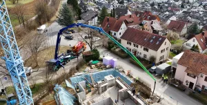 An aerial view of the new Volvo Trucks and Putzmeister fully electric alternative for pumping concrete in action on a construction site. 