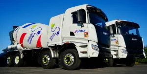 Two of Cemex's new electric trucks, which are designed for urban use, offering up to a 100% reduction in CO₂ emissions when powered by renewable energy and operate at significantly lower noise levels than traditional diesel-powered vehicles.